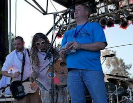 Rich Fisher introducing a band on stage in 2011